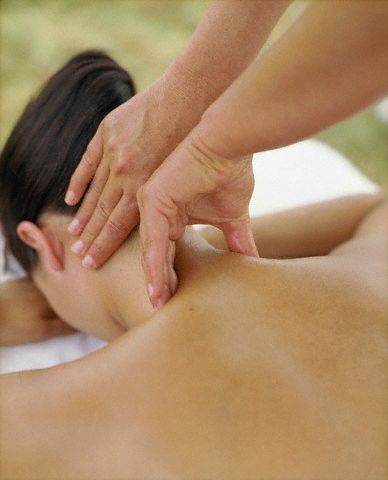 A Woman Receiving a Massage on Their Neck and Shoulders
